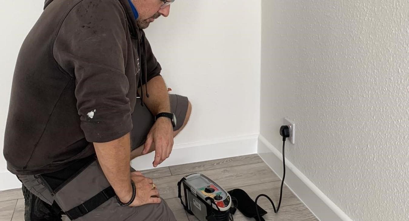 Electrician testing a socket